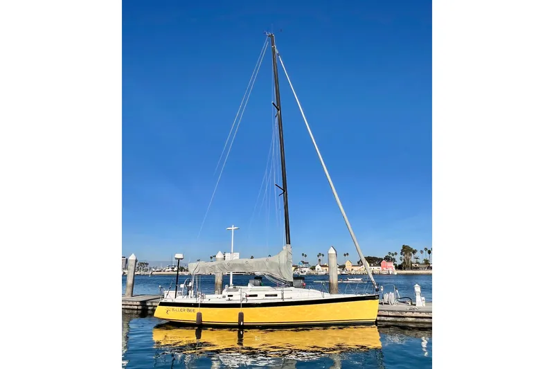 Slide: The Image of Yellow 2003 J Boats J/109 sailboat docked in a marina under clear blue skies. - 4