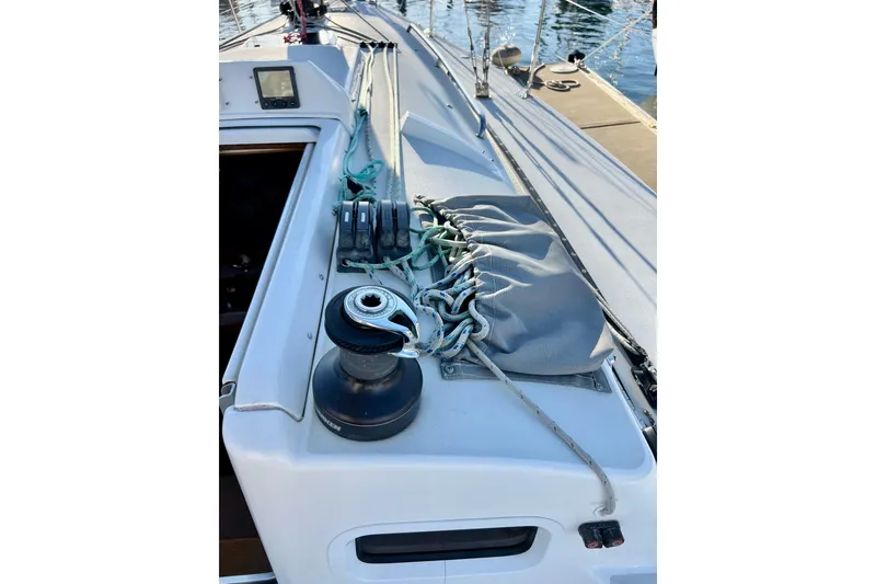 Slide: The Image of 2003 J Boats J/109 sailboat deck with winch and ropes, docked at marina. - 42