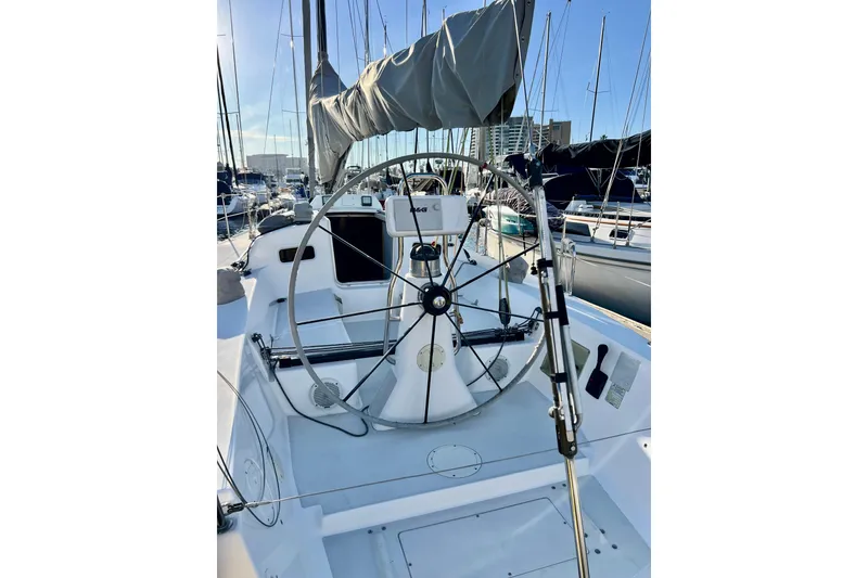 Slide: The Image of 2003 J Boats J/109 sailboat cockpit with steering wheel, docked in marina. - 47