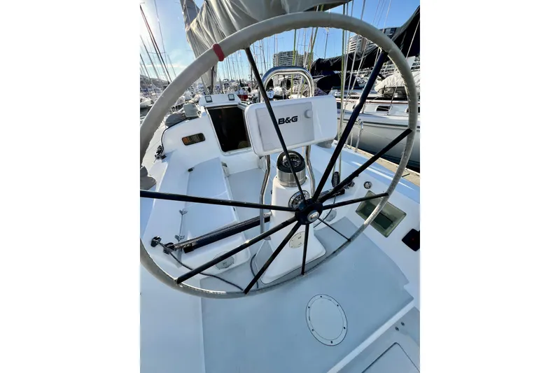 Slide: The Image of 2003 J Boats J/109 sailboat cockpit with steering wheel and navigation equipment. - 48