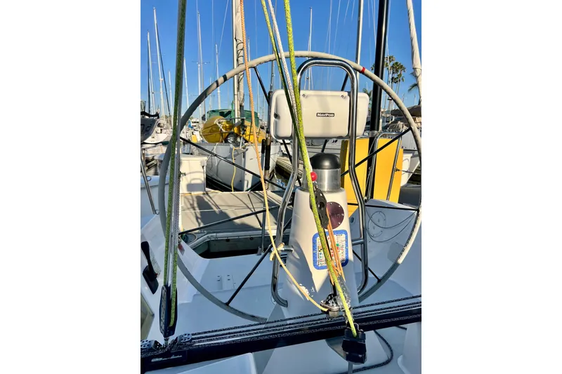 Slide: The Image of Steering wheel of a 2003 J Boats J/109 sailboat docked at a marina. - 50