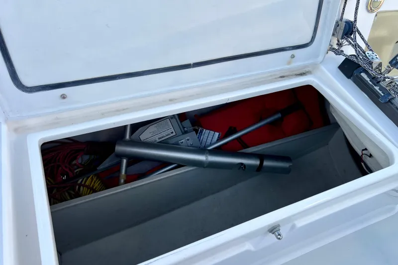 Slide: The Image of Open storage compartment on a 2003 J Boats J/109, containing boating equipment and ropes. - 52