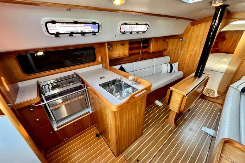 Slide: The Image of Interior of 2003 J Boats J/109 sailboat with wood finish, kitchenette, and seating area. - 55