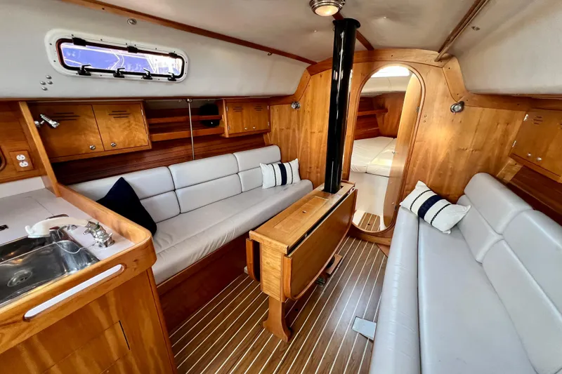 Slide: The Image of Interior of 2003 J Boats J/109 sailboat with wood finish and cozy seating. - 56