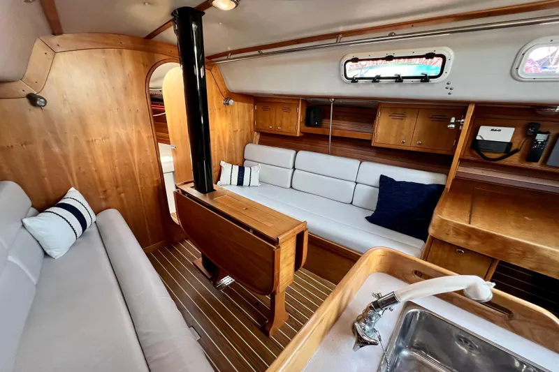 Slide: The Image of Interior of 2003 J Boats J/109 sailboat with wooden finish and cozy seating area. - 57