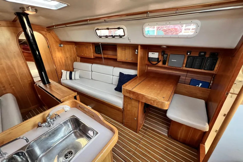 Slide: The Image of Interior of 2003 J Boats J/109 sailboat with wood finish and seating area. - 58