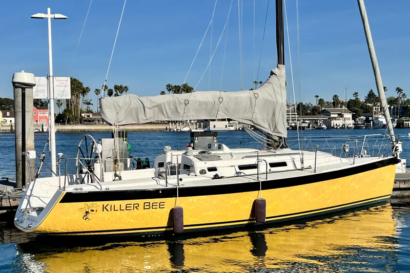Slide: The Image of Yellow 2003 J Boats J/109 sailboat named "Killer Bee" docked at marina. - 6