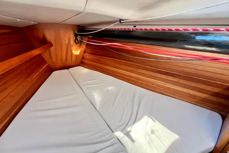 Slide: The Image of Interior cabin of 2003 J Boats J/109 with wooden paneling and cozy bedding. - 65