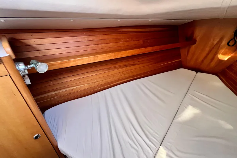Slide: The Image of Cozy cabin interior of 2003 J Boats J/109 with wooden paneling and comfortable bedding. - 66