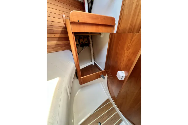 Slide: The Image of Interior of 2003 J Boats J/109 sailboat with wooden cabinetry and seating area. - 69