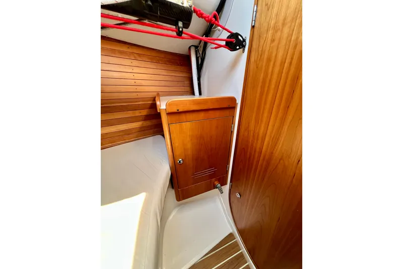 Slide: The Image of Interior of 2003 J Boats J/109 sailboat with wooden cabinetry and seating area. - 70