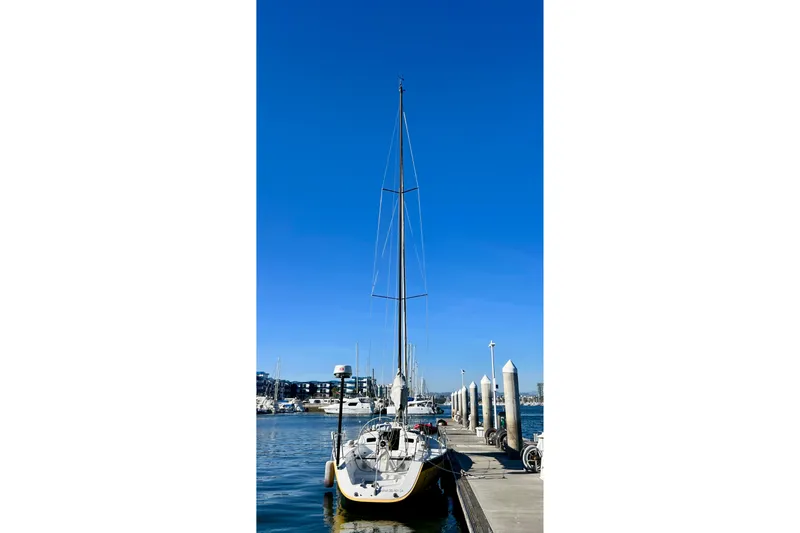 Slide: The Image of 2003 J Boats J/109 sailboat docked at marina under clear blue sky. - 8