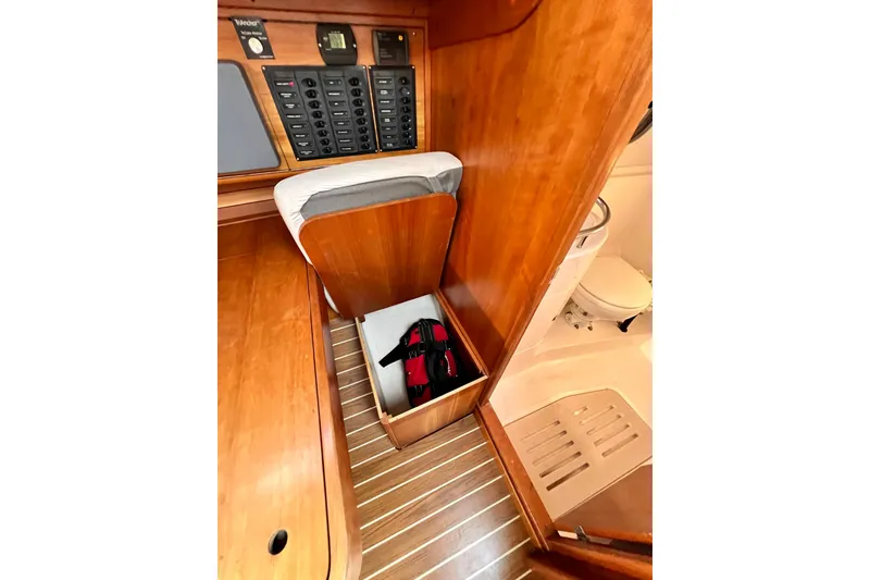 Slide: The Image of Interior of 2003 J Boats J/109 showing wooden cabinetry and storage compartment. - 81