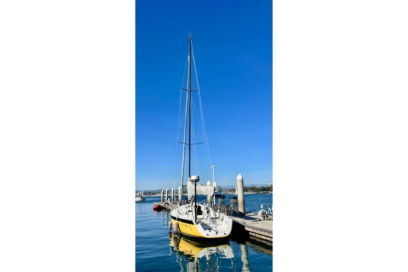 Slide: The Image of 2003 J Boats J/109 sailboat docked under clear blue sky. - 9