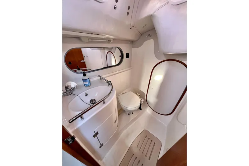 Slide: The Image of Bathroom interior of 2003 J Boats J/109 yacht, featuring sink, mirror, and toilet. - 90