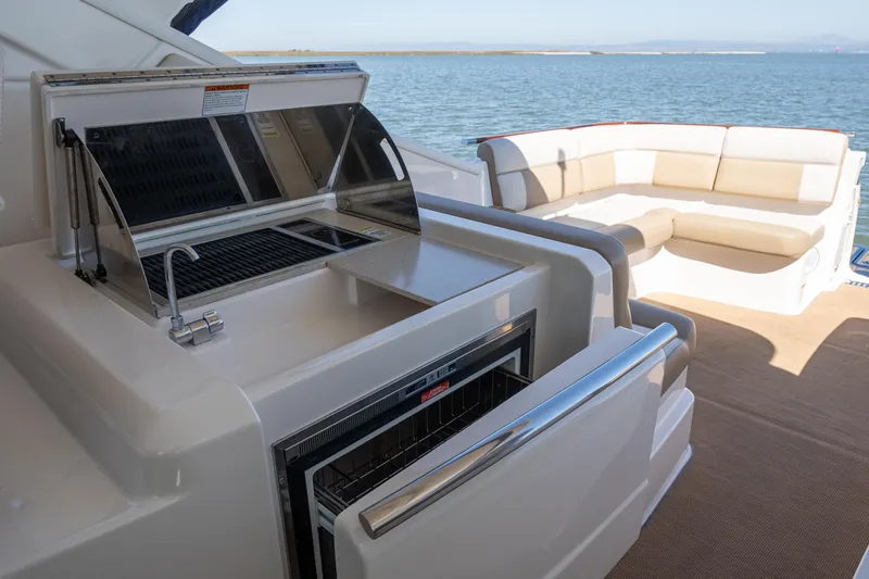Slide: The Image of 2012 Tiara Yachts 3100 Coronet with grill and seating area by the water. - 15