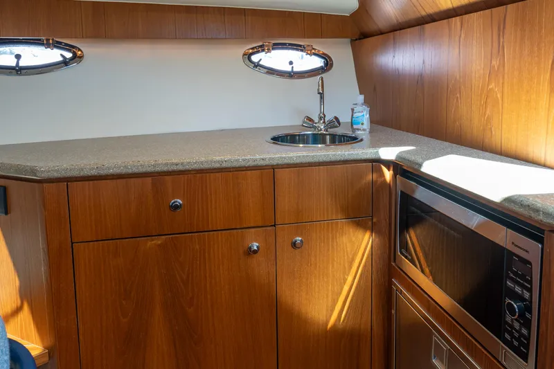 Slide: The Image of Interior of 2012 Tiara Yachts 3100 Coronet featuring modern kitchenette. - 21