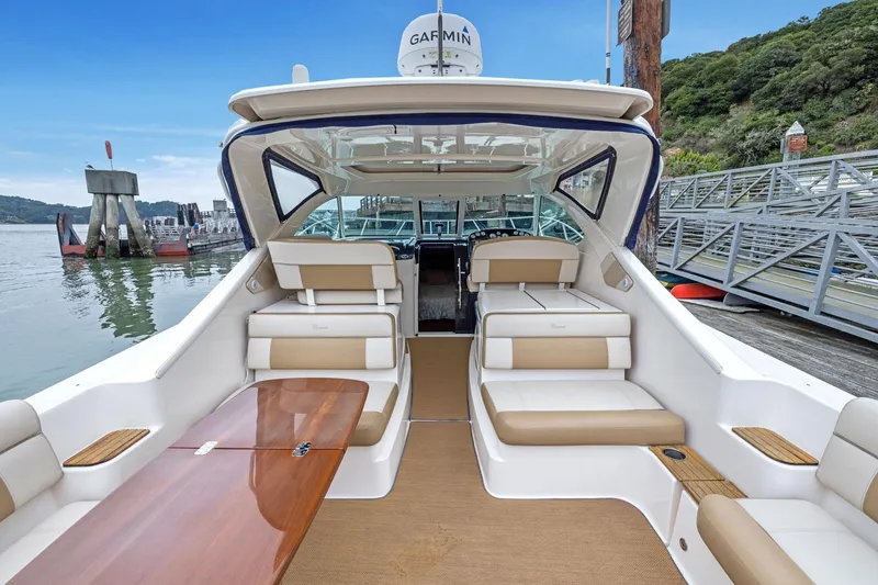 Slide: The Image of 2012 Tiara Yachts 3100 Coronet docked, featuring spacious seating and elegant interior design. - 44