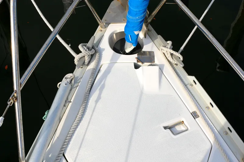 Slide: The Image of Bow of a 1993 Hunter 33.5 sailboat with ropes and anchor holder. - 13