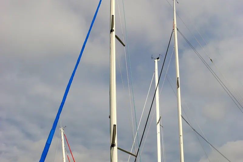 Slide: The Image of Masts of a 1993 Hunter 33.5 sailboat against a cloudy sky. - 20