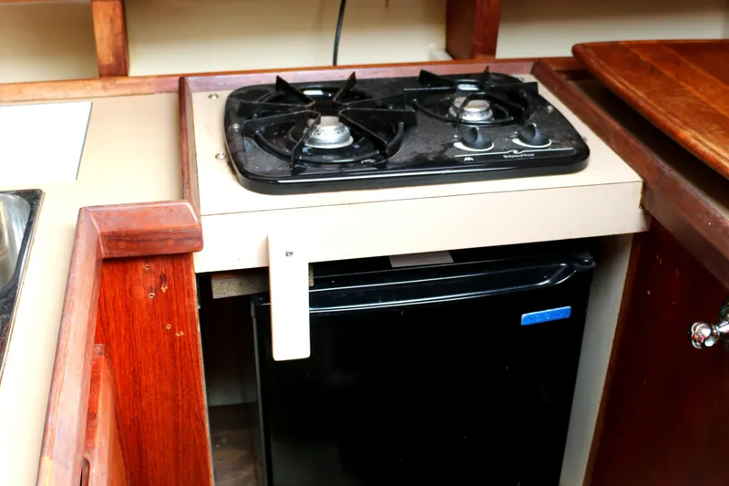 Slide: The Image of Galley area in a 1993 Hunter 33.5 yacht with stove and fridge. - 26