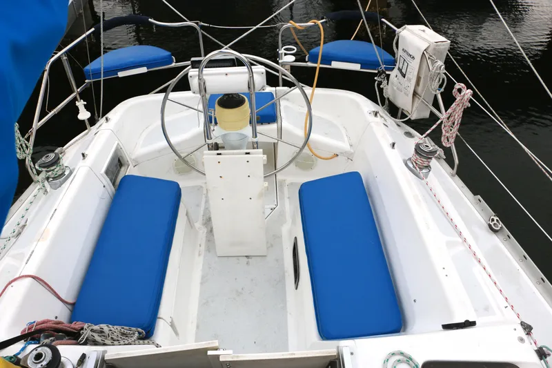 Slide: The Image of Cockpit of a 1993 Hunter 33.5 sailboat with blue cushions. - 4