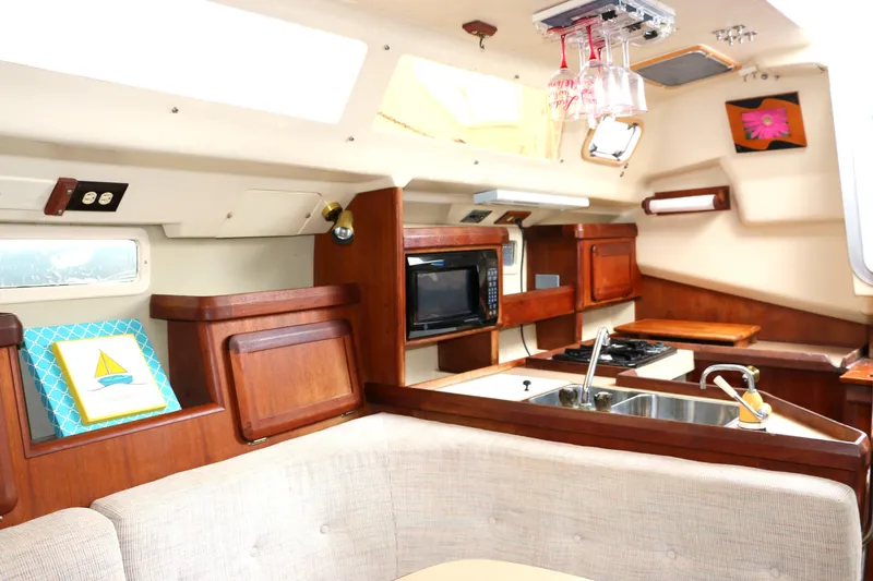 Slide: The Image of Interior of a 1993 Hunter 33.5 yacht with kitchen and seating area. - 41
