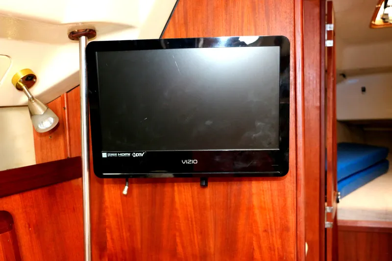 Slide: The Image of TV mounted on wooden wall in 1993 Hunter 33.5 yacht. - 42