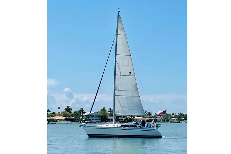 Slide: The Image of Sailboat on water, 1993 Hunter 33.5 model, clear sky, coastal background. - 53