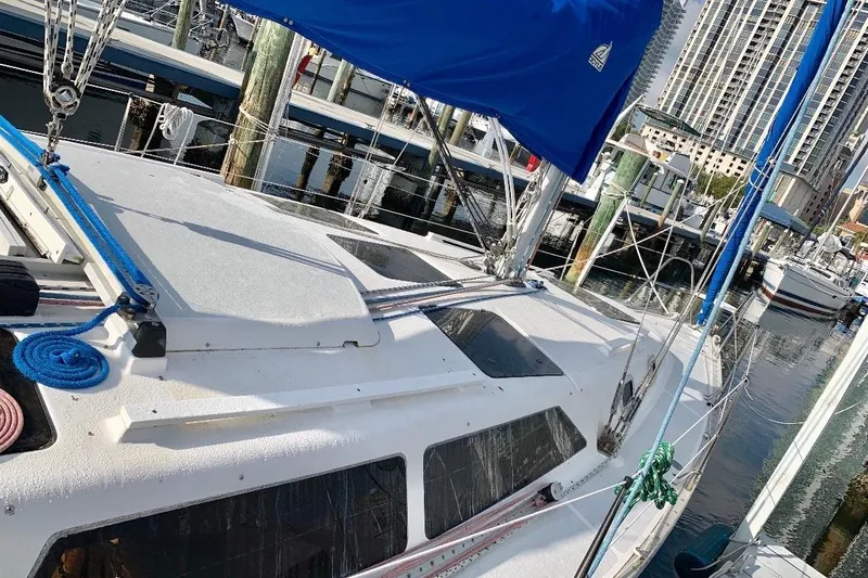 Slide: The Image of Sailboat Hunter 33.5, 1993 model, docked at marina with blue sail cover. - 54