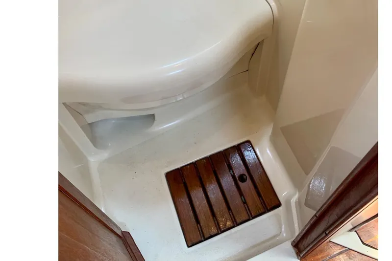 Slide: The Image of Bathroom area of a 1993 Hunter 33.5 boat with wooden floor panel. - 58