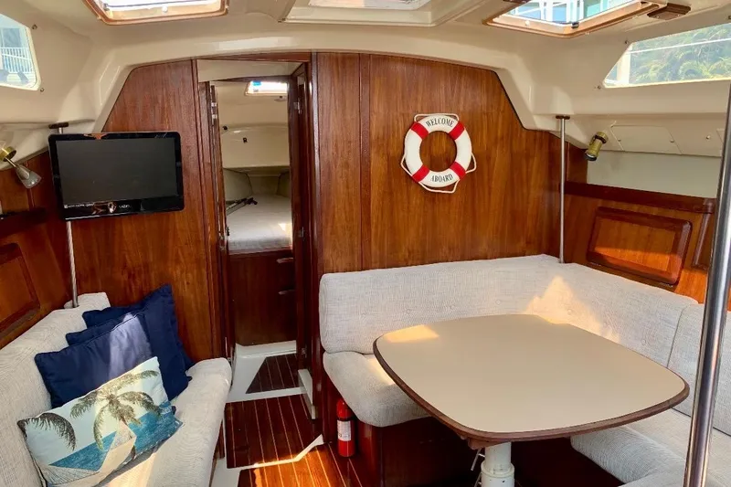Slide: The Image of Cozy interior of 1993 Hunter 33.5 sailboat with seating, table, and TV. - 60