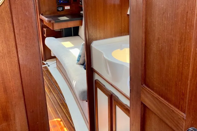 Slide: The Image of Interior of 1993 Hunter 33.5 sailboat with wooden finish and cozy seating area. - 61