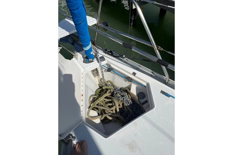 Slide: The Image of Anchor locker on 1993 Hunter 33.5 sailboat with ropes and chain. - 62