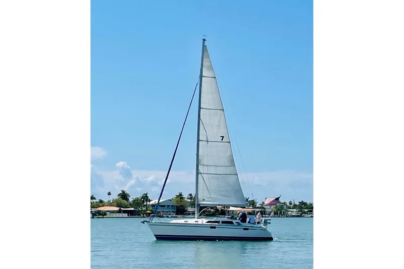 Slide: The Image of Sailboat on calm water, 1993 Hunter 33.5 model, clear blue sky background. - 64