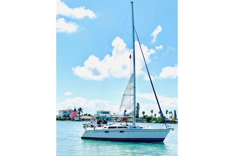 Slide: The Image of Sailboat Hunter 33.5 (1993) cruising on a sunny day with clear skies. - 65