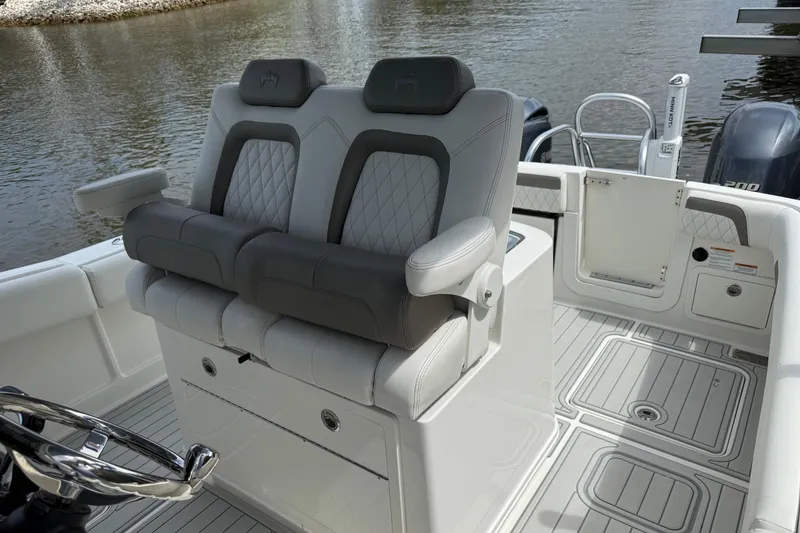 Slide: The Image of Luxury seating on 2021 World Cat 280 CC-X boat, featuring dual cushioned seats and sleek design. - 12
