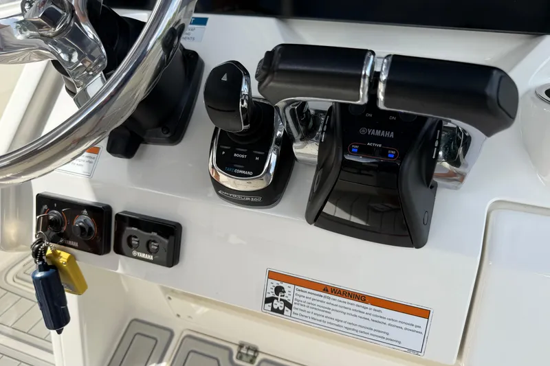 Slide: The Image of Control panel of 2021 World Cat 280 CC-X boat with Yamaha throttle and steering wheel. - 15