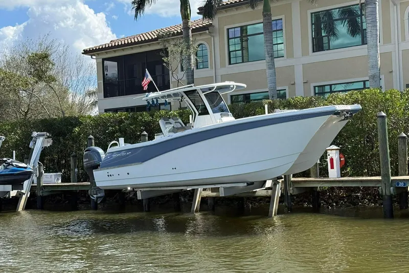 The Image of 2021 World Cat 280 CC-X boat docked near waterfront home with palm trees. - 2