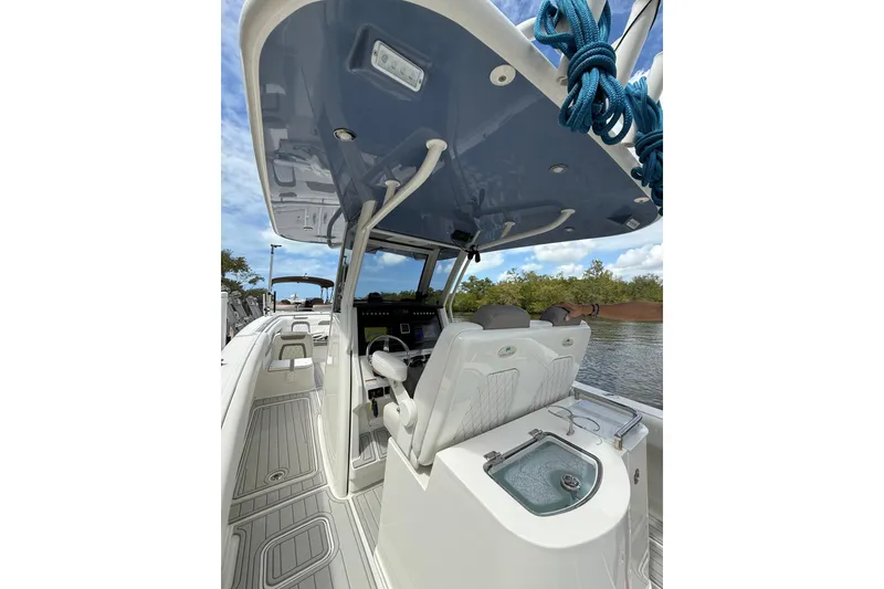 Slide: The Image of 2021 World Cat 280 CC-X boat interior with helm, seating, and overhead storage. - 23