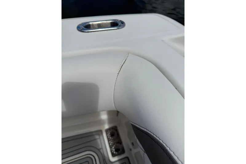 Slide: The Image of Close-up of 2021 World Cat 280 CC-X boat interior, featuring white upholstery and stainless steel details. - 24