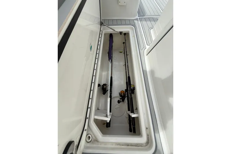 Slide: The Image of 2021 World Cat 280 CC-X boat storage compartment with fishing rods. - 25