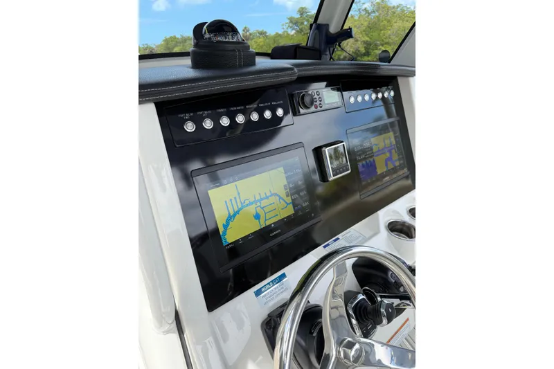 Slide: The Image of 2021 World Cat 280 CC-X boat dashboard with navigation screens and controls. - 26