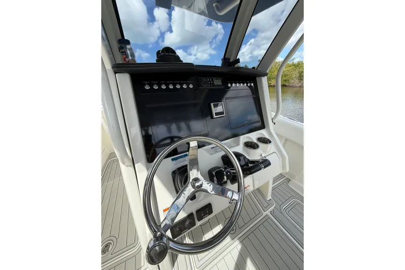Slide: The Image of Steering console of 2021 World Cat 280 CC-X boat with modern controls and navigation. - 4