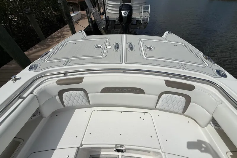 Slide: The Image of 2021 World Cat 280 CC-X boat interior with cushioned seating and storage compartments. - 7