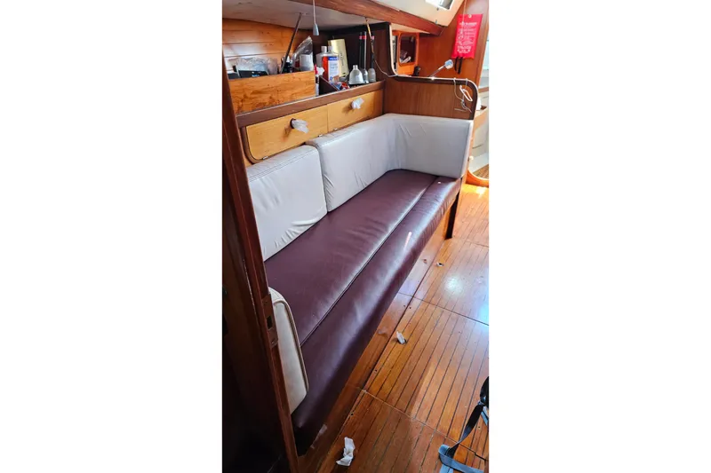 Slide: The Image of Interior of 1989 Gib'Sea 37 sailboat with wooden flooring and cushioned seating. - 10