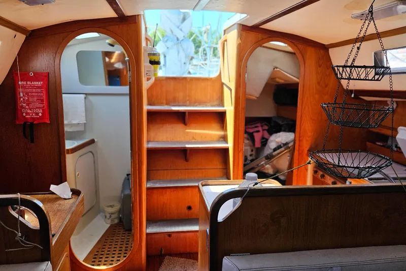 Slide: The Image of Interior of a 1989 Gib'Sea 37 sailboat, featuring wooden cabinetry and cozy living space. - 18