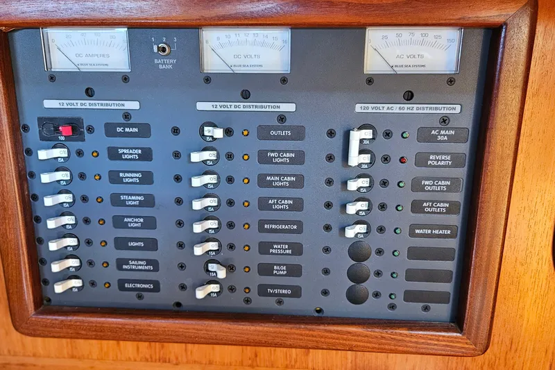 Slide: The Image of Electrical control panel on a 1989 Gib'Sea 37 sailboat, featuring various switches and meters. - 20