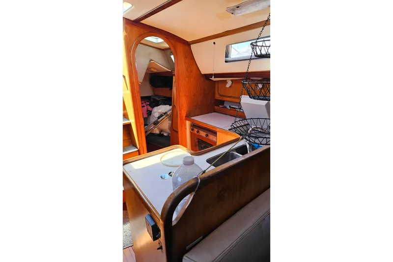 Slide: The Image of Interior of 1989 Gib'Sea 37 sailboat with wooden cabinetry and compact kitchen area. - 25