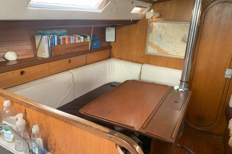 Slide: The Image of Cozy interior of 1989 Gib'Sea 37 sailboat with wooden furnishings and a map. - 28